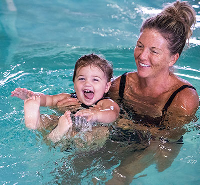 Mom holding child in the water