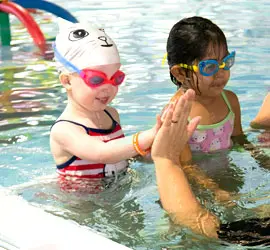 swim-school-1 Swim school student giving a high five