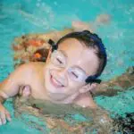 student smiling in the water