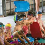 students waiting at poolside