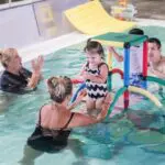 instructors and students playing in the water